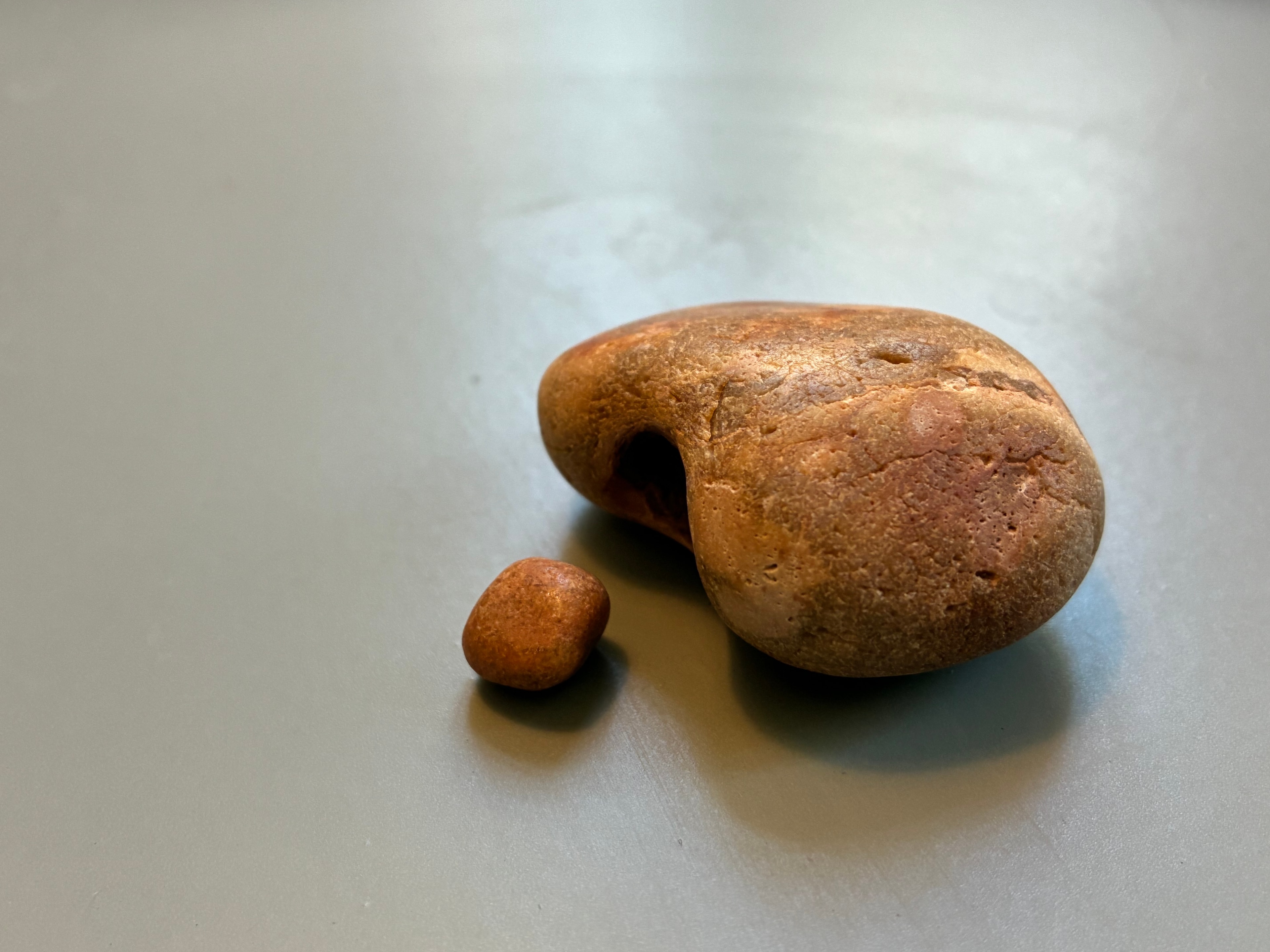 Two smooth stones on a grey surface